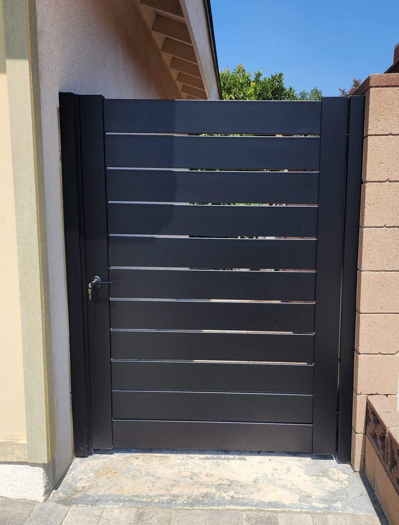 Black aluminum semi-privacy fence gate, weather-resistant design ideal for DIY homeowners seeking durable solutions