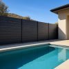 Black semi-privacy aluminum fencing with 6-inch horizontal slats providing modern poolside screening
