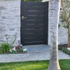 Do-it-yourself aluminum gate kit with modern black horizontal slats, lockable latch, and homeowner-friendly installation