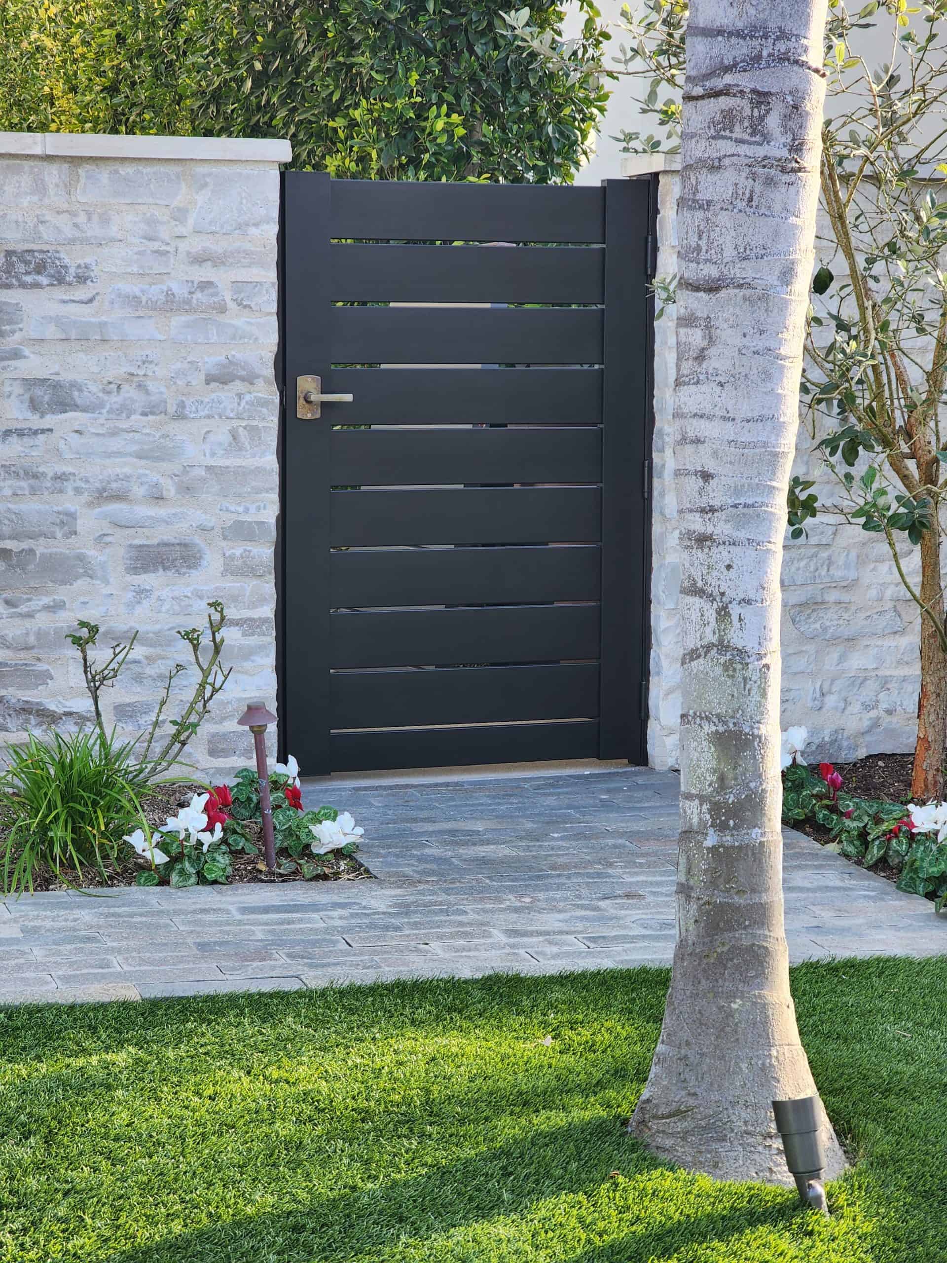 Do-it-yourself aluminum gate kit with modern black horizontal slats, lockable latch, and homeowner-friendly installation