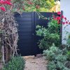 Durable black aluminum privacy fence gate, modern horizontal slat style, perfect for home improvement projects
