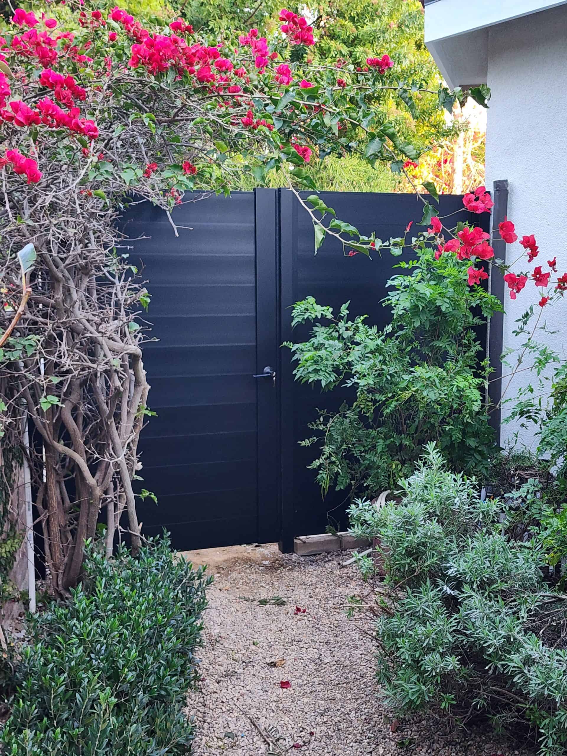 Durable black aluminum privacy fence gate, modern horizontal slat style, perfect for home improvement projects