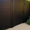 Tall black aluminum privacy gate providing security and sleek design for backyard access