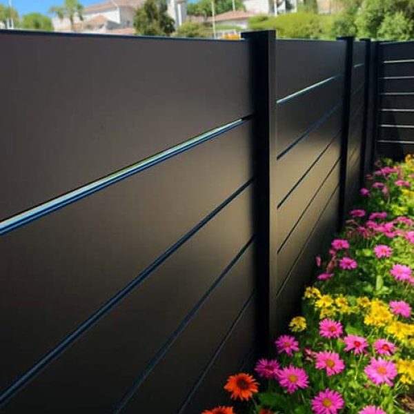 aluminum-horizontal-slat-fencing-providing-backyard-privacy-with-decorative-garden-view